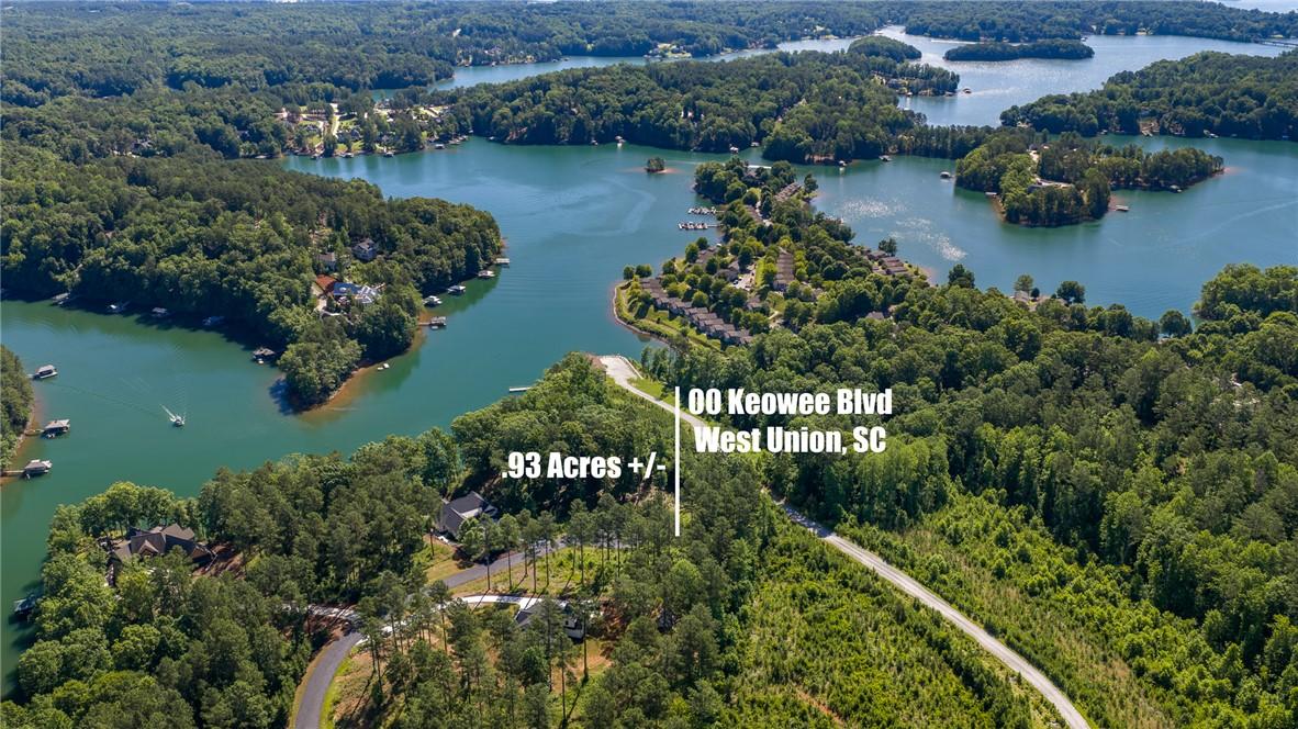 Image 2: A tranquil waterfront lot awaits, surrounded by lu