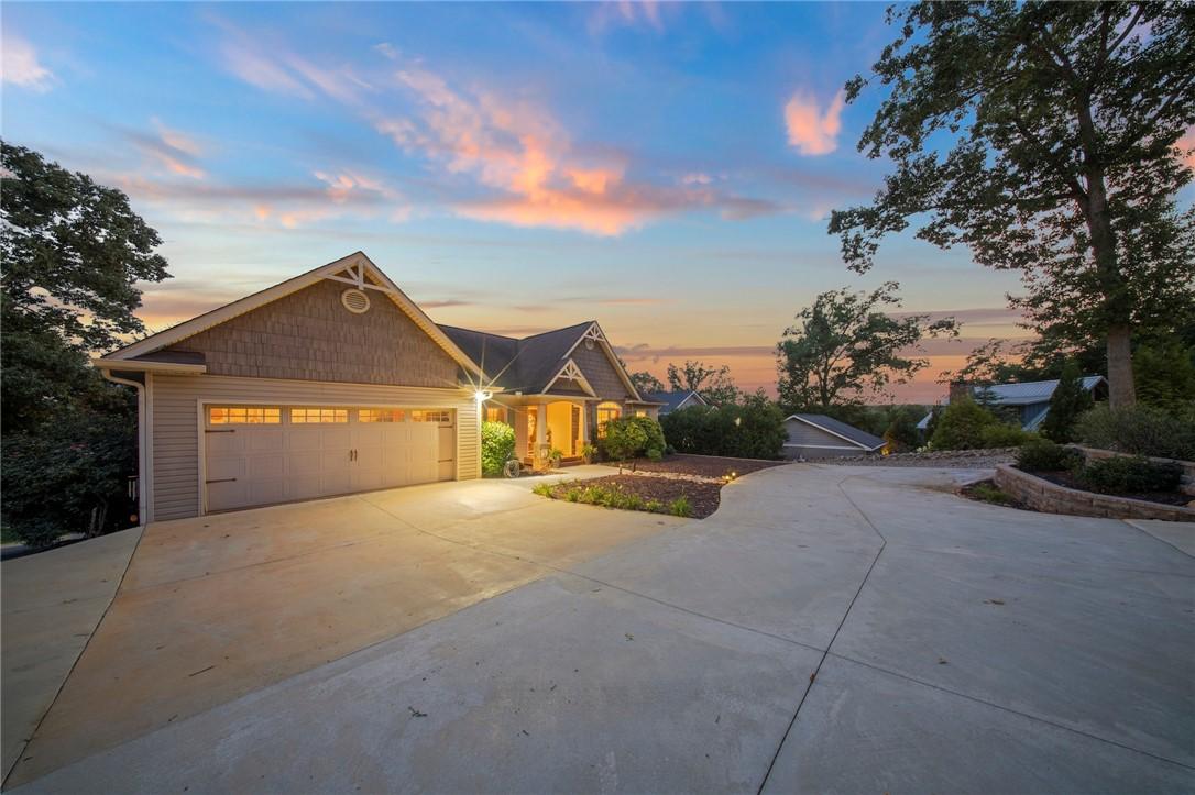 Image 3: Concrete driveway leads to a welcoming home with a