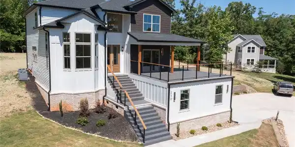 Image 2: This home features a charming exterior with a spac