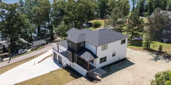 Image 4: This modern home offers expansive lake views and a