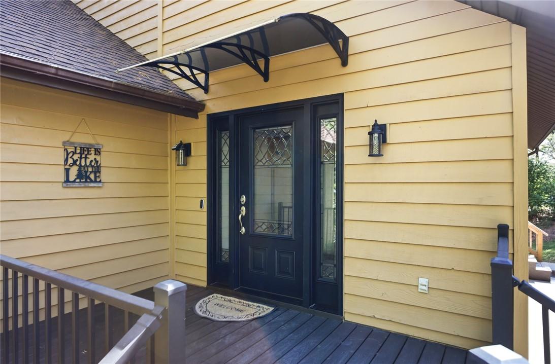 Image 3: This inviting entrance features a dark wood door a