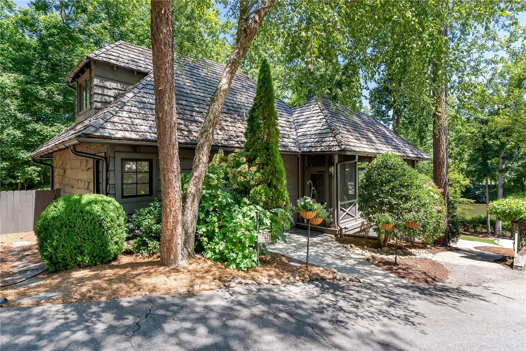 Image 2: A quaint home nestles among lush greenery, featuri