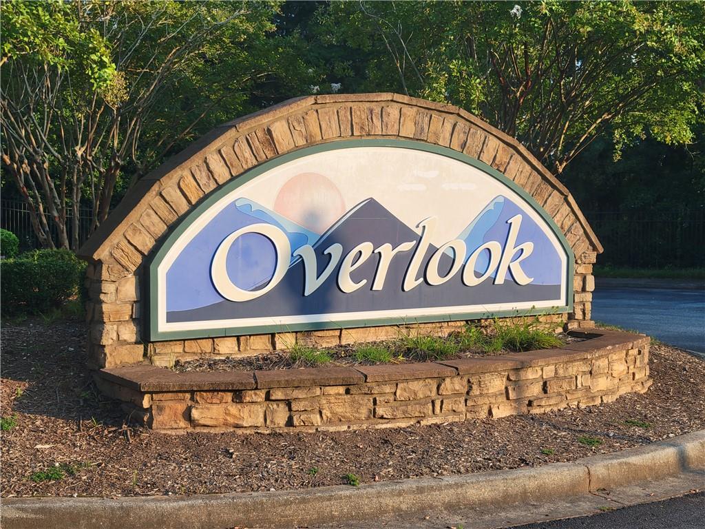 Image 2: A welcoming stone-clad entrance sign introduces th