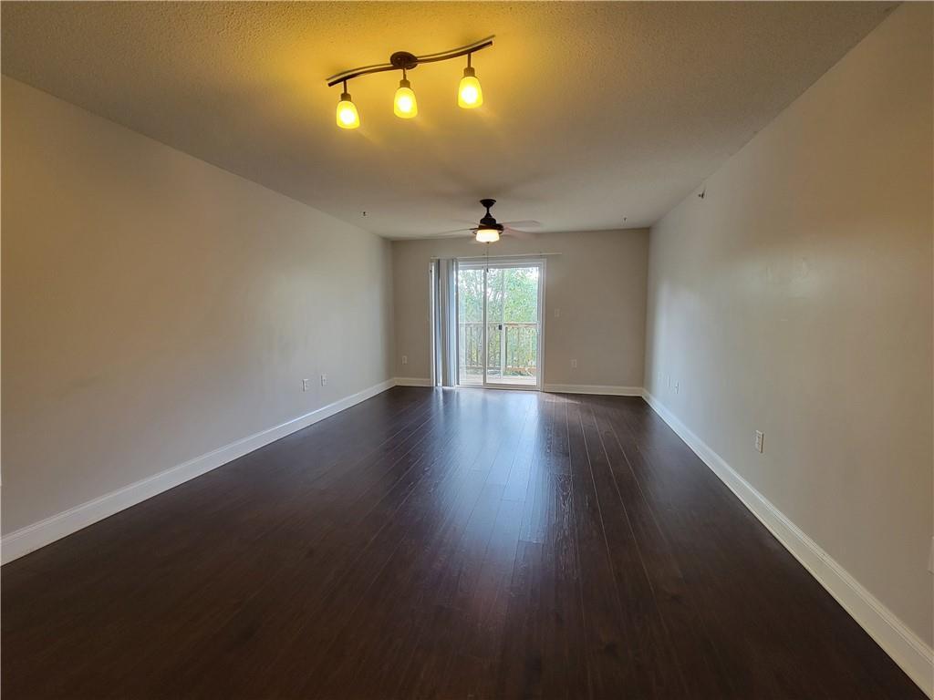 Image 4: Rich hardwood flooring extends through this natura