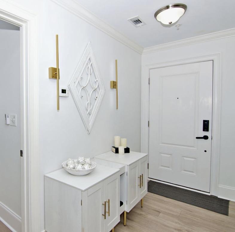 Image 3: This bright entrance foyer welcomes all with a cle
