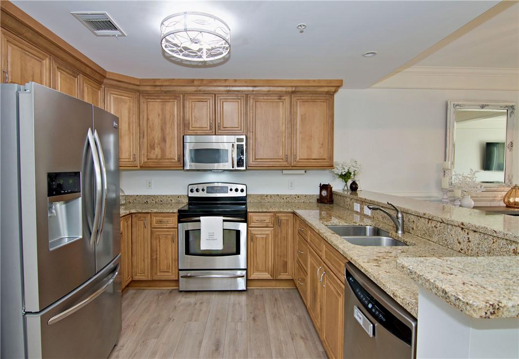 Image 4: This bright kitchen features ample counter space a