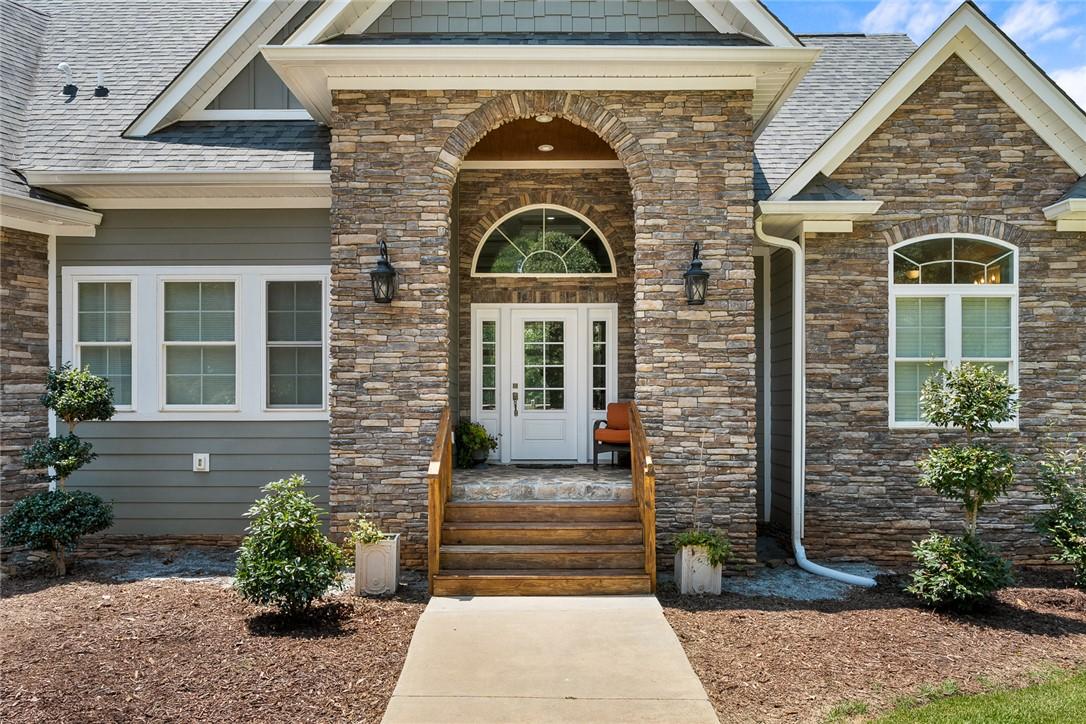 Image 4: A welcoming stone and siding facade creates a char
