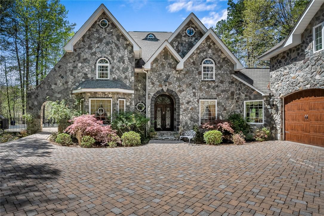 Image 2: This magnificent stone facade residence features a