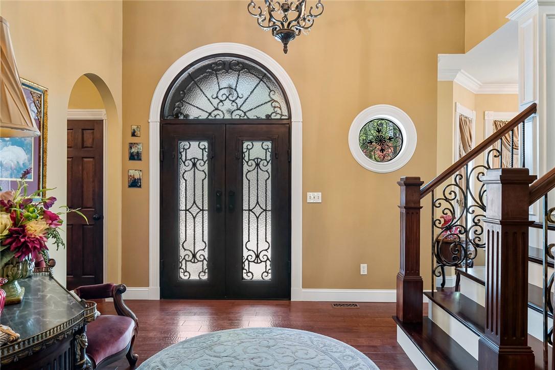 Image 3: Elegant hardwood flooring graces this inviting ent