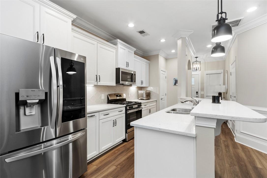 Image 4: This bright kitchen features sleek appliances and