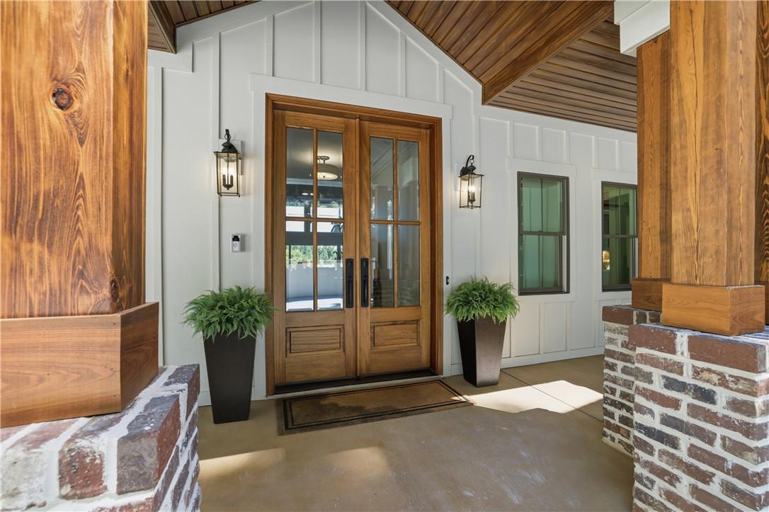Image 4: Rich wooden double doors welcome guests to this in