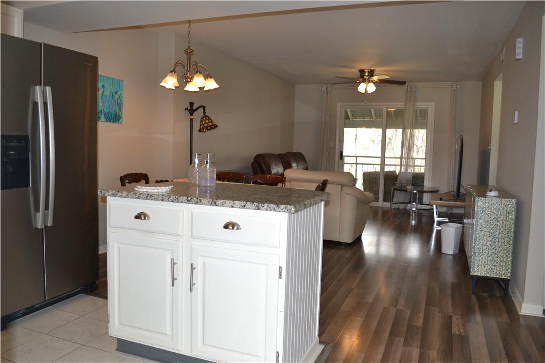 Image 4: This inviting space combines kitchen and living ar