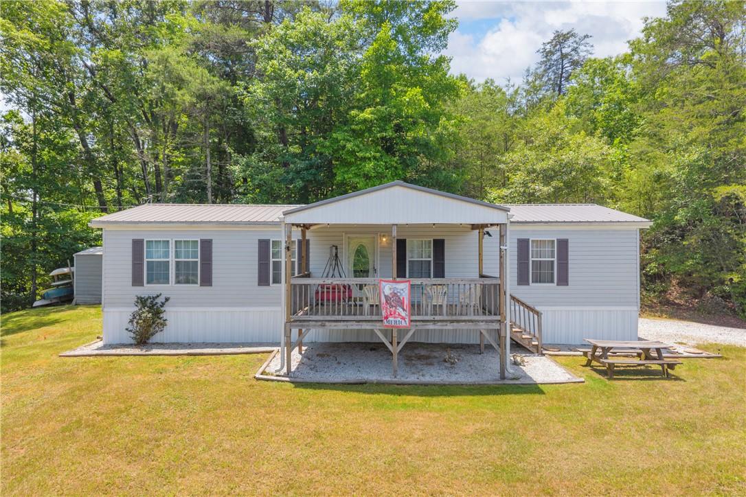 Image 1: An inviting covered porch offers a warm welcome to