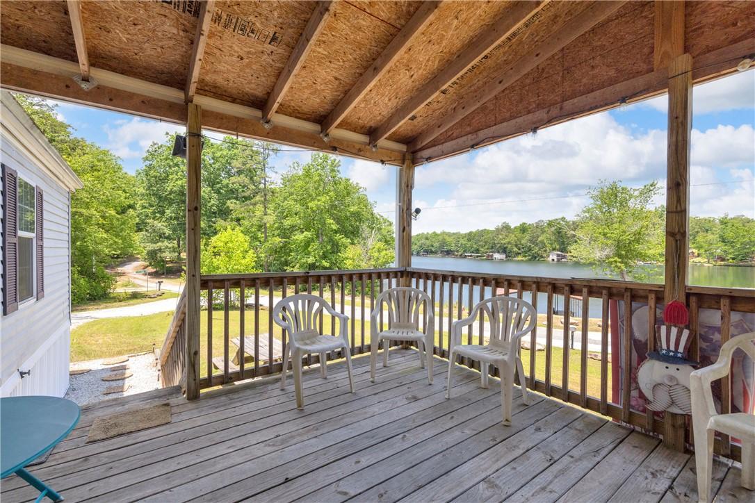 Image 4: A spacious wooden deck provides tranquil views of