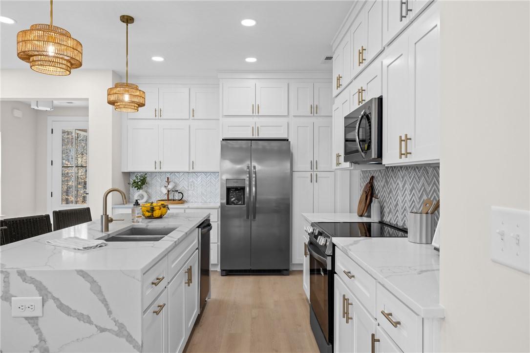 Image 4: This bright kitchen features sleek appliances and