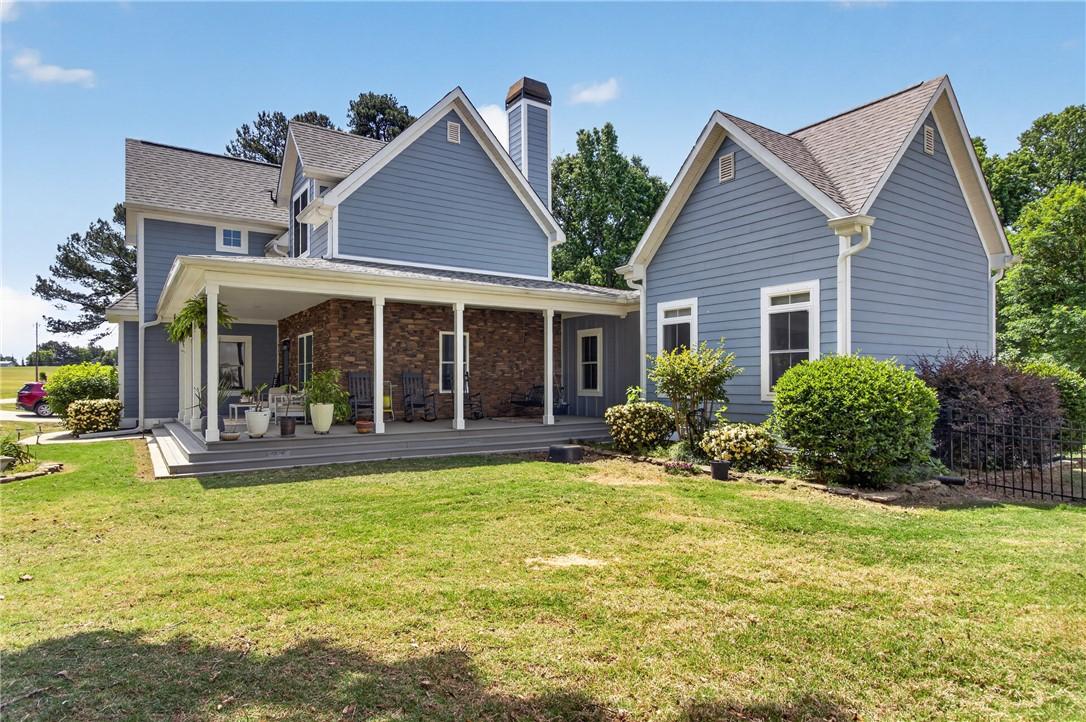 Image 2: This charming residence features an inviting cover