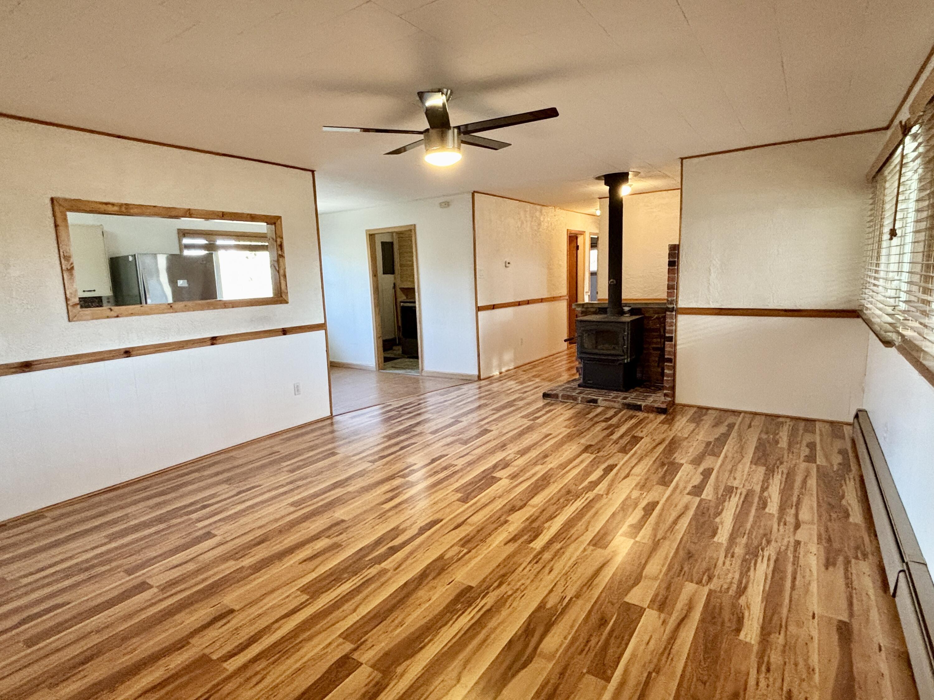Image 3: Living w/newer wood stove/flooring